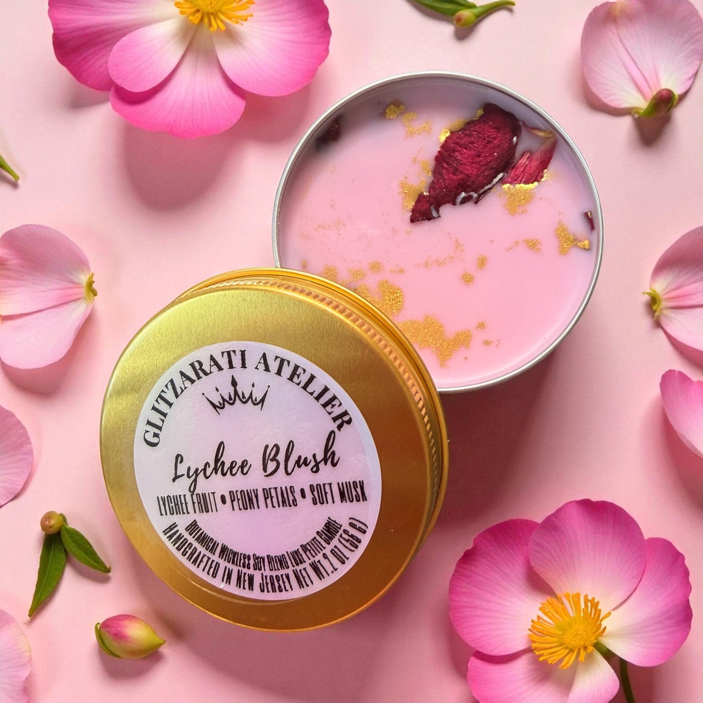 Pink soft mousse in a tin with a gold lid on a pink background with flowers