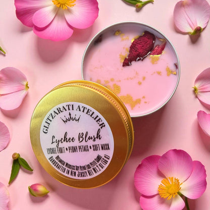 Pink soft mousse in a tin with a gold lid on a pink background with flowers