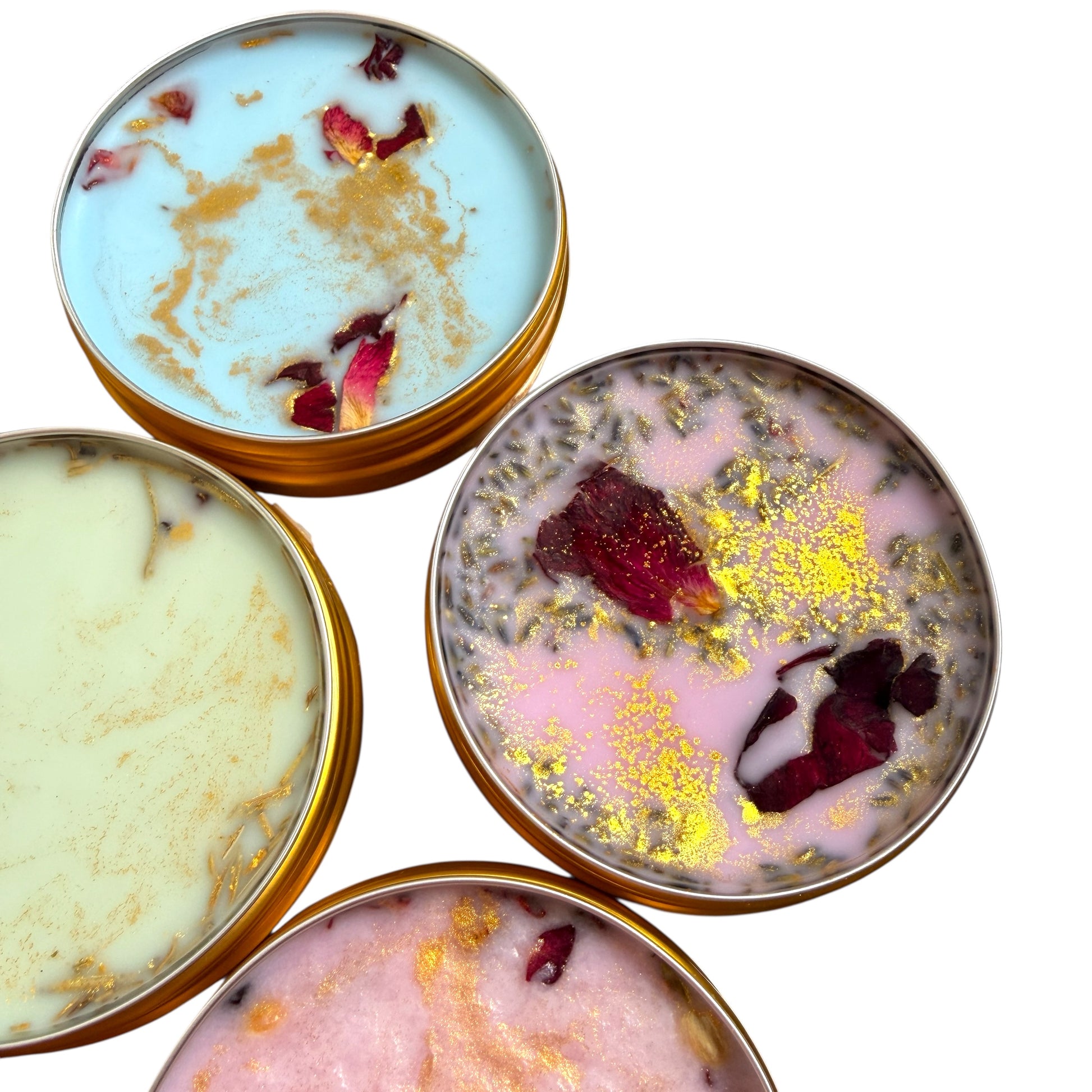 Four small containers with decorative contents on a white background