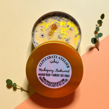 Scented candle with decorative elements on a peach background