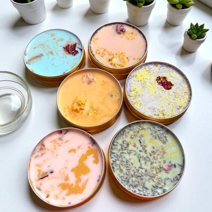 Stacks of colorful ceramic plates with decorative elements on a white surface.