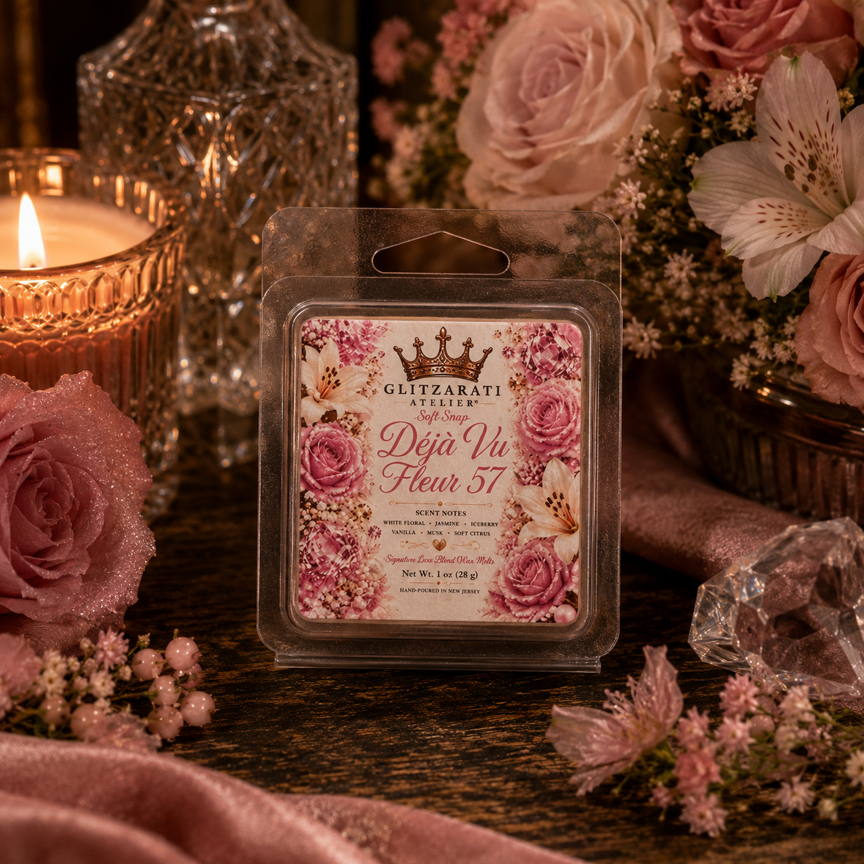 Floral wax melt packaging with roses and a lit candle on a decorative surface