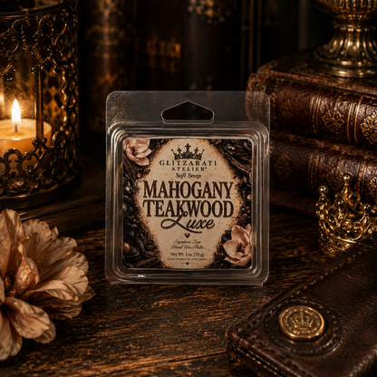 Packaged soap bar labeled 'Mahogany Teakwood Luxe' on a wooden surface with decorative elements.