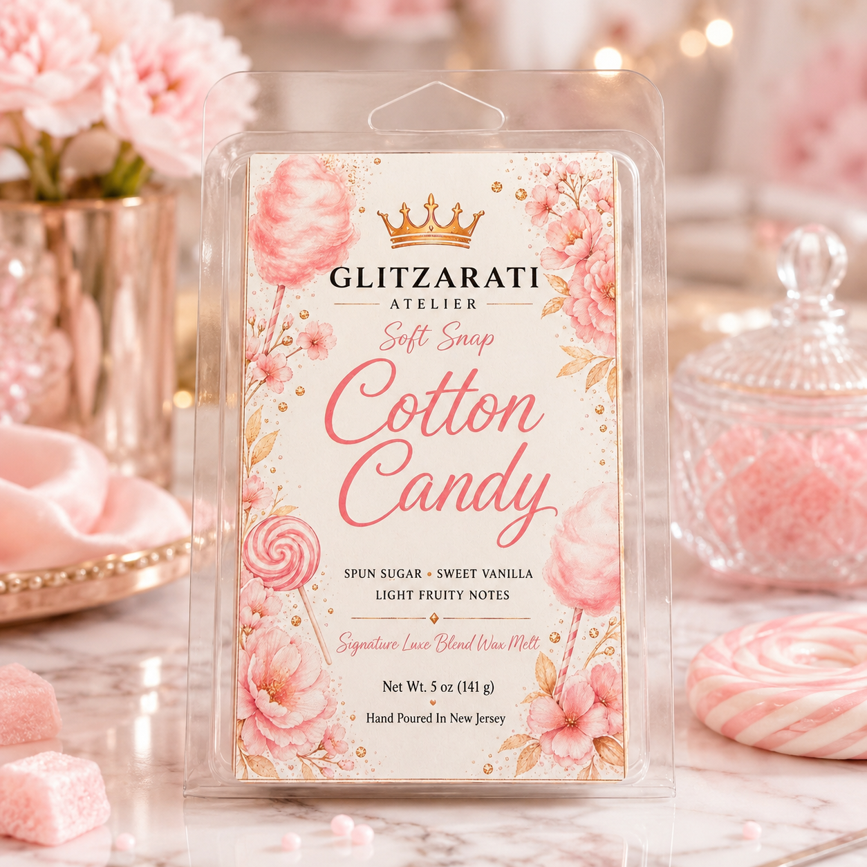 Packaged cotton candy with floral design and 'Glitzerati Atelier' branding on a decorative background.