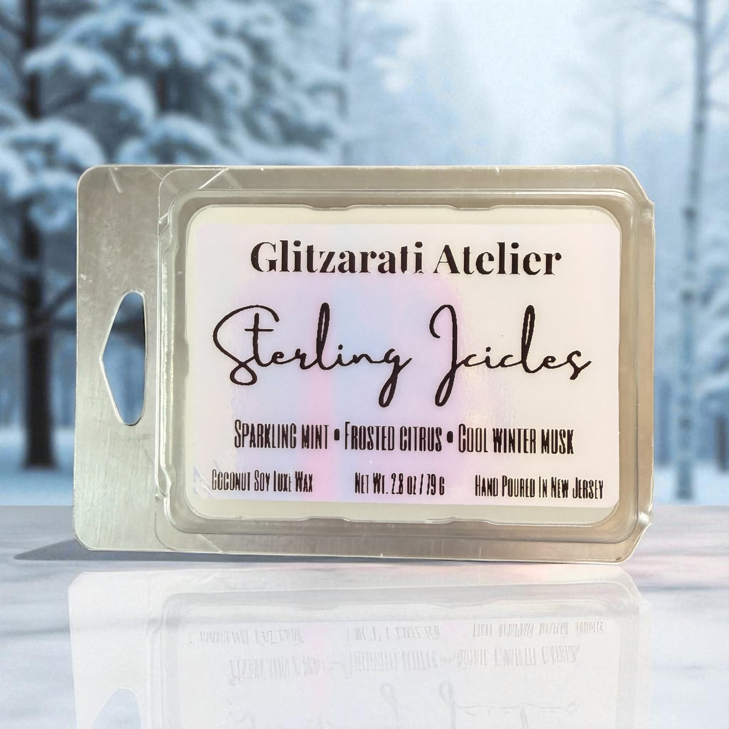 Wax melt package with 'Glitzerati Atelier' branding against a snowy background